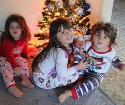 3 children at christmas tree